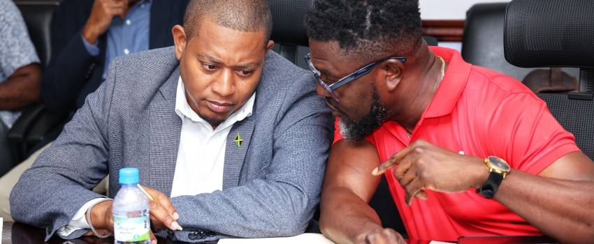 Minister of Agriculture, Fisheries and Mining, Hon. Floyd Green (left), converses with GraceKennedy (GK) General Insurance Company Limited’s Client and Partner Services Manager, Orette Duncan, during the handover ceremony for an insurance payout totalling $2.88 million to registered farmers affected by Hurricane Melissa. The payout was disbursed under the GraceKennedy Weather Protection Programme administered by GraceKennedy (GK) General Insurance Company Limited. The ceremony was held at the Ministry of Ag